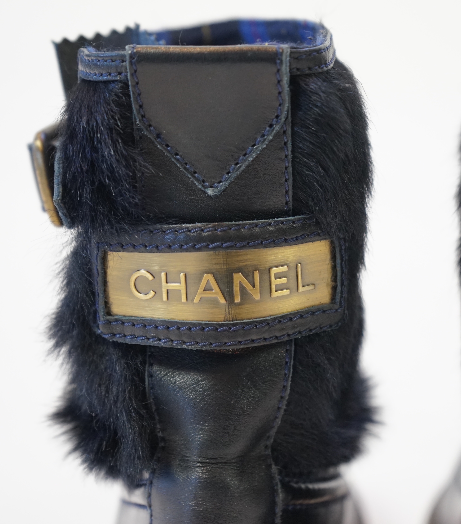 A pair of Chanel lady's navy blue leather calf hair pleated belted buckle boots, size EU 40.5
